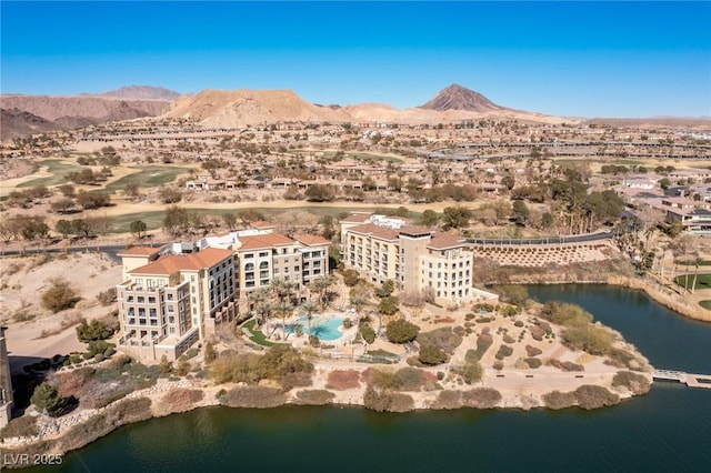 drone / aerial view with a water and mountain view