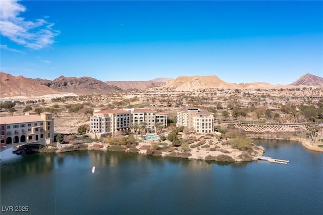 drone / aerial view with a water and mountain view