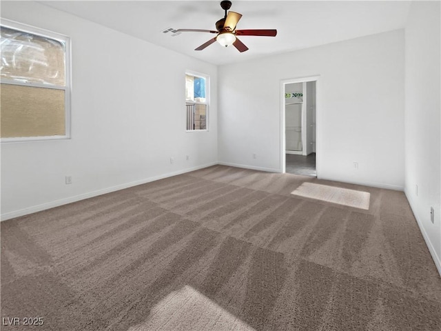 carpeted spare room featuring ceiling fan