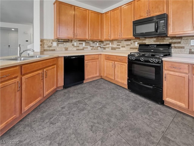 kitchen featuring black appliances, dark tile patterned flooring, sink, and tasteful backsplash