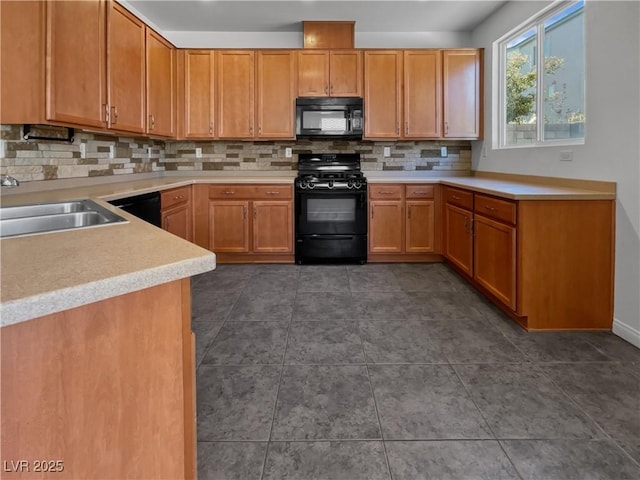 kitchen with dark tile patterned floors, sink, backsplash, and black appliances