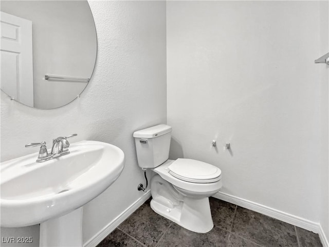 bathroom featuring toilet and sink