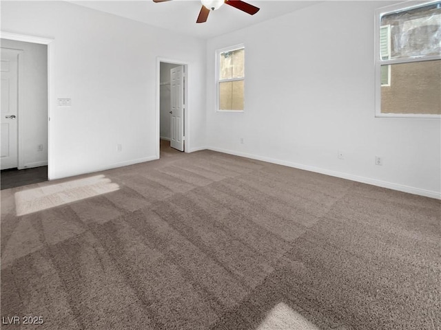 carpeted empty room featuring ceiling fan