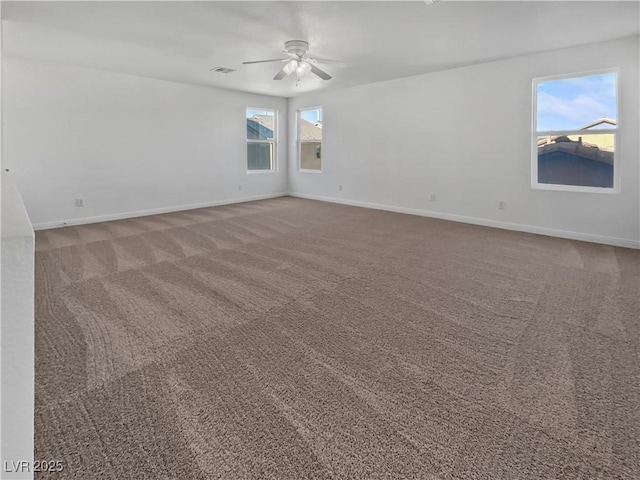 empty room with ceiling fan and carpet