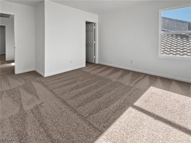 unfurnished room featuring dark colored carpet