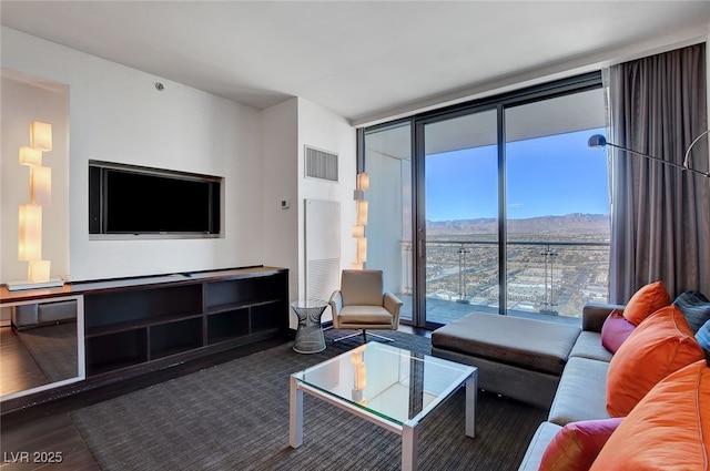 living room with a mountain view, dark hardwood / wood-style floors, and expansive windows