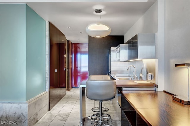 kitchen featuring a breakfast bar and sink