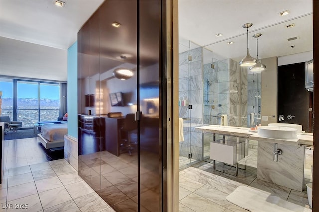 bathroom with vanity, a mountain view, an enclosed shower, and expansive windows