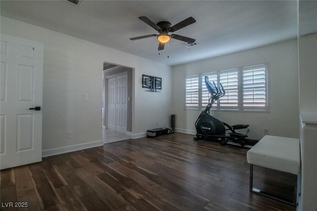 workout area featuring ceiling fan and dark hardwood / wood-style floors