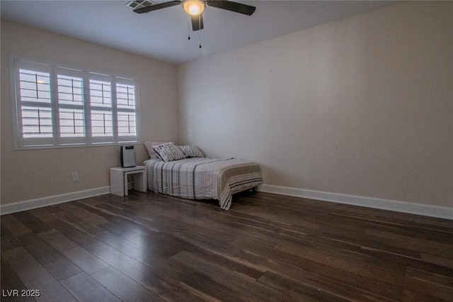 unfurnished bedroom with ceiling fan and dark hardwood / wood-style floors