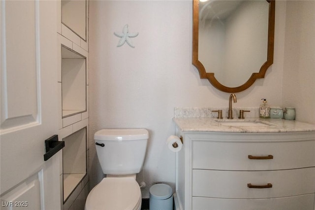 bathroom with toilet and vanity