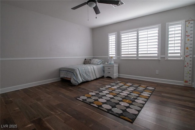 unfurnished bedroom with ceiling fan and dark hardwood / wood-style floors