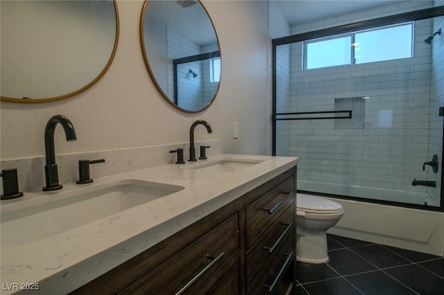 full bathroom featuring toilet, combined bath / shower with glass door, tile patterned floors, and vanity