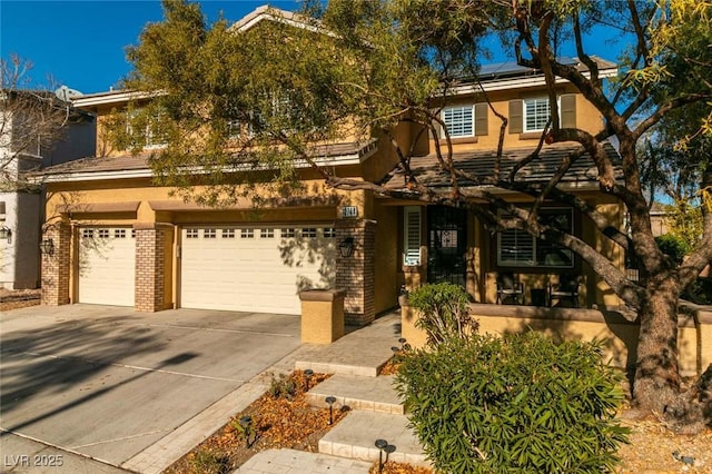 view of front of property with a garage and solar panels