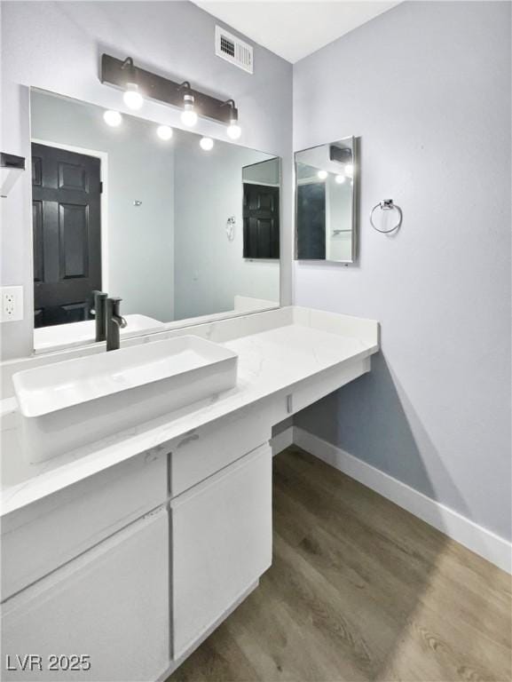 bathroom featuring hardwood / wood-style flooring and vanity