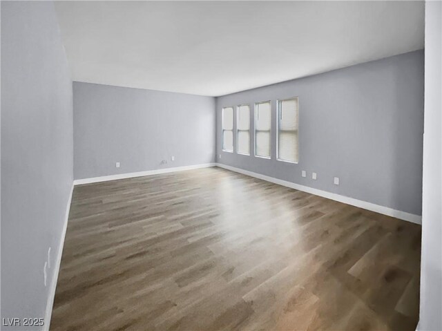 spare room featuring dark hardwood / wood-style flooring