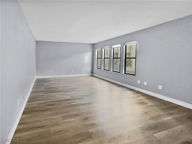 empty room with hardwood / wood-style flooring