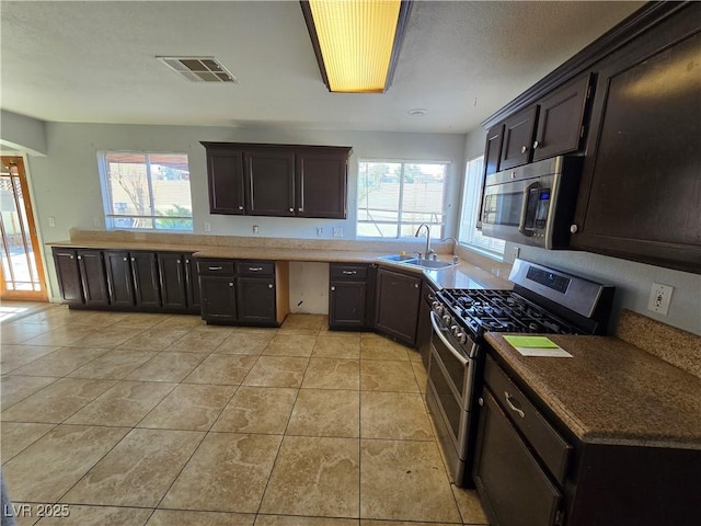 kitchen featuring light tile patterned flooring, appliances with stainless steel finishes, sink, and plenty of natural light