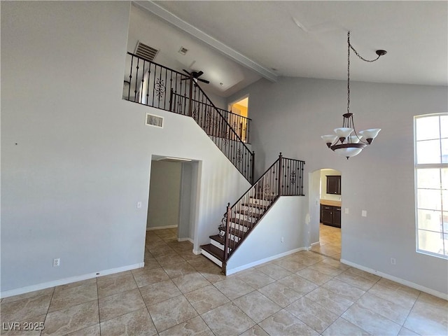 interior space featuring high vaulted ceiling, beam ceiling, tile patterned flooring, and ceiling fan with notable chandelier