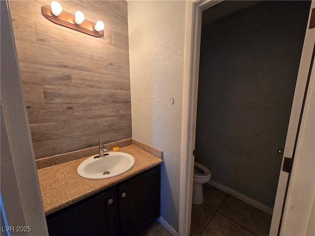 bathroom featuring toilet, tile patterned floors, and vanity