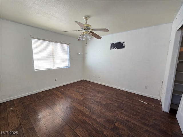 spare room featuring ceiling fan, dark hardwood / wood-style flooring, and a textured ceiling