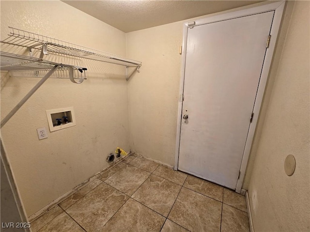 clothes washing area with washer hookup and a textured ceiling