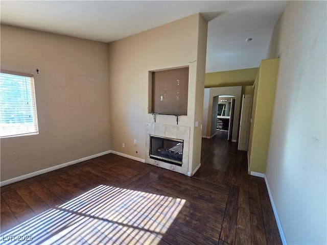 unfurnished living room with a fireplace and dark hardwood / wood-style floors