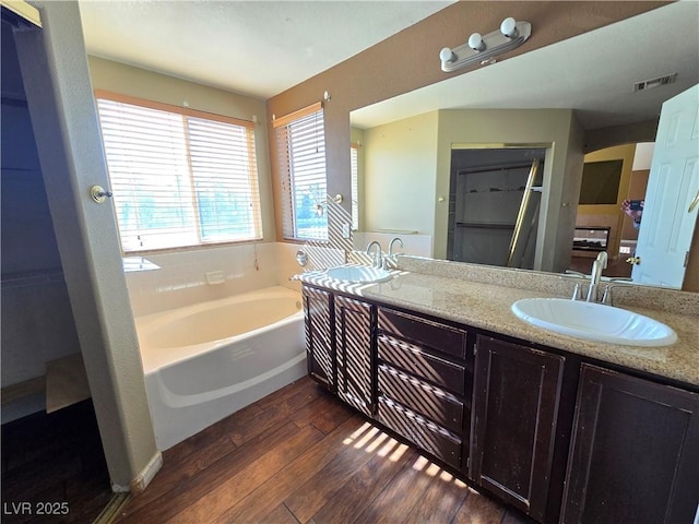 bathroom featuring hardwood / wood-style flooring, a bathtub, and vanity