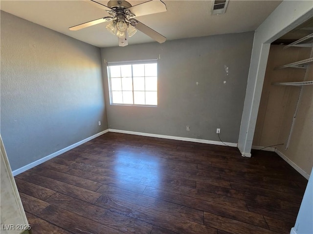 unfurnished bedroom featuring ceiling fan, a closet, and dark hardwood / wood-style floors