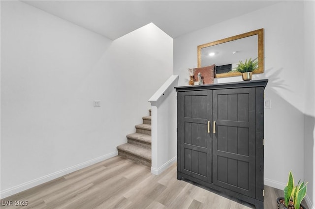 stairs with hardwood / wood-style flooring