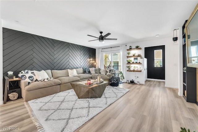 living room with light wood-type flooring and ceiling fan