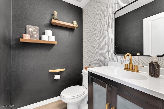 bathroom with toilet and vanity