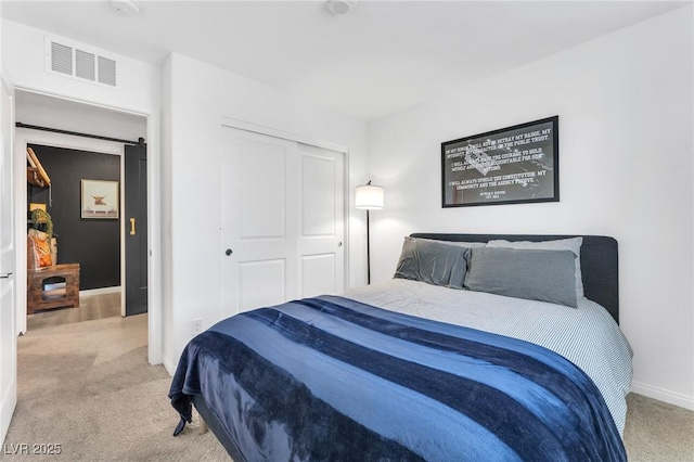 bedroom with light carpet and a closet