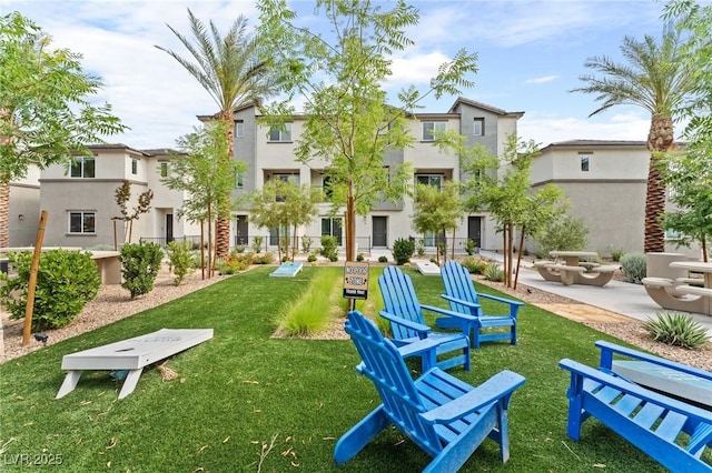 view of community featuring a yard and a patio