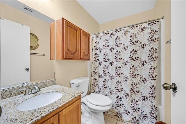 bathroom featuring toilet, vanity, and tile patterned floors