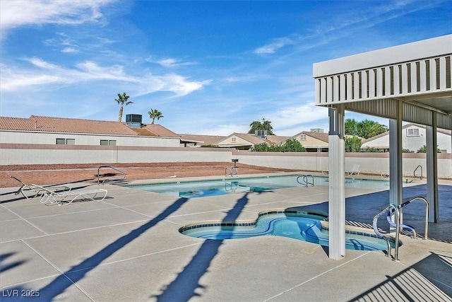 view of pool with a patio area and a community hot tub