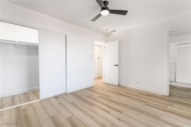 unfurnished bedroom featuring ceiling fan, a closet, and light hardwood / wood-style floors