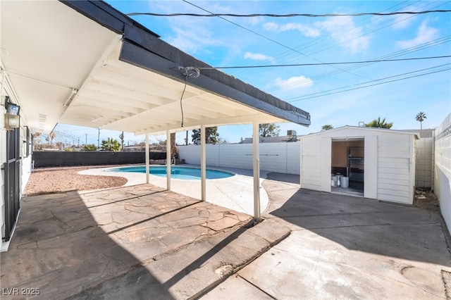 view of pool featuring a storage unit and a patio