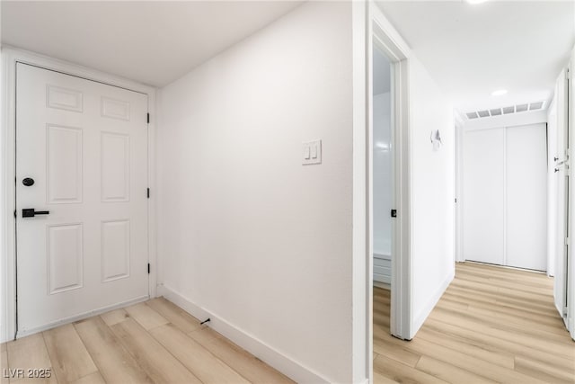 corridor featuring light hardwood / wood-style floors