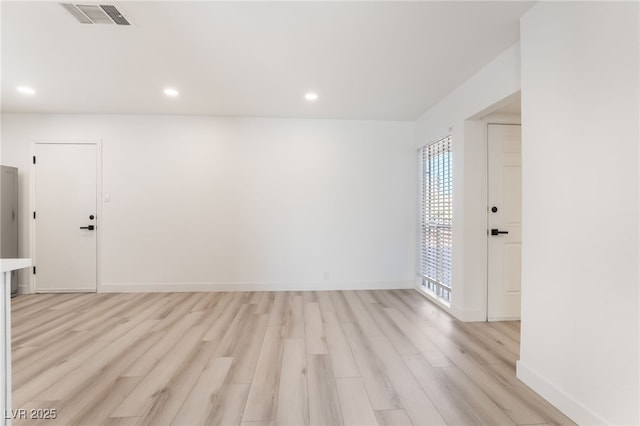 spare room featuring light wood-type flooring