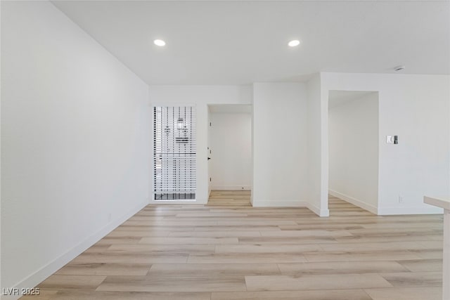 unfurnished room with light wood-type flooring