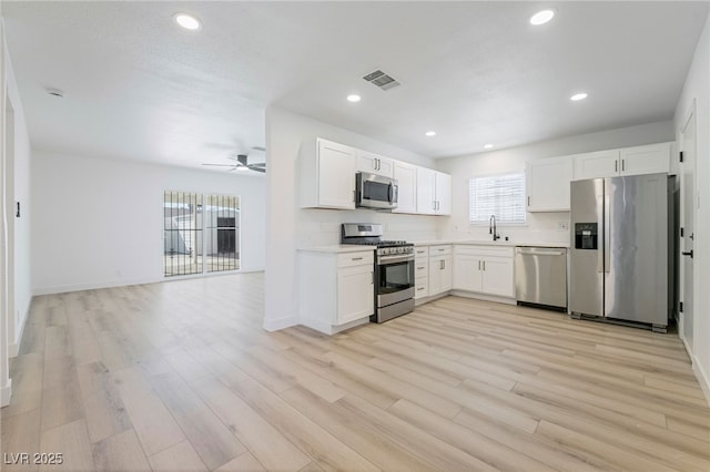 kitchen featuring sink, stainless steel appliances, and white cabinetry