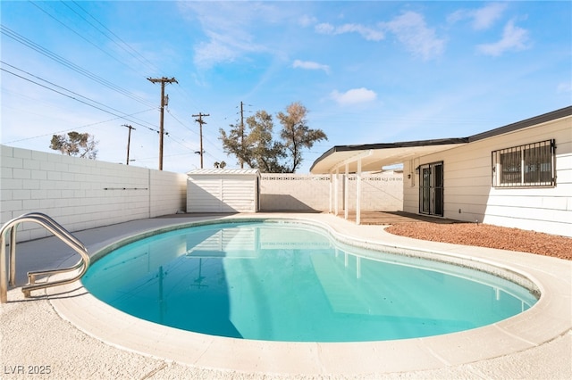 view of swimming pool featuring a storage unit