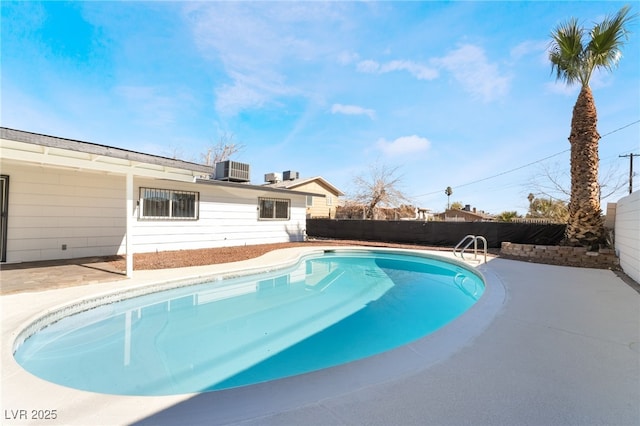 view of pool featuring a patio and central air condition unit