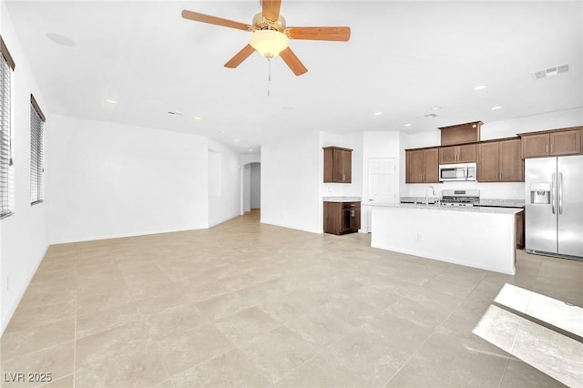 5640 Akula Bay St, North Las Vegas, NV 89081 - unfurnished living room with a ceiling fan, recessed lighting, and a sink