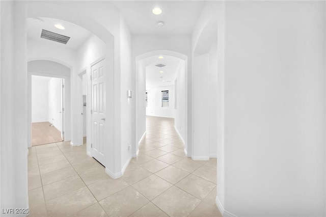 5640 Akula Bay St, North Las Vegas, NV 89081 - corridor with light tile patterned floors, arched walkways, recessed lighting, and baseboards