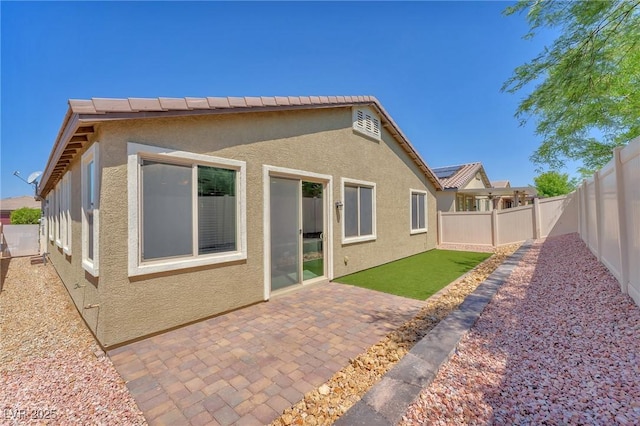 5640 Akula Bay St, North Las Vegas, NV 89081 - back of property with stucco siding, a fenced backyard, and a patio area