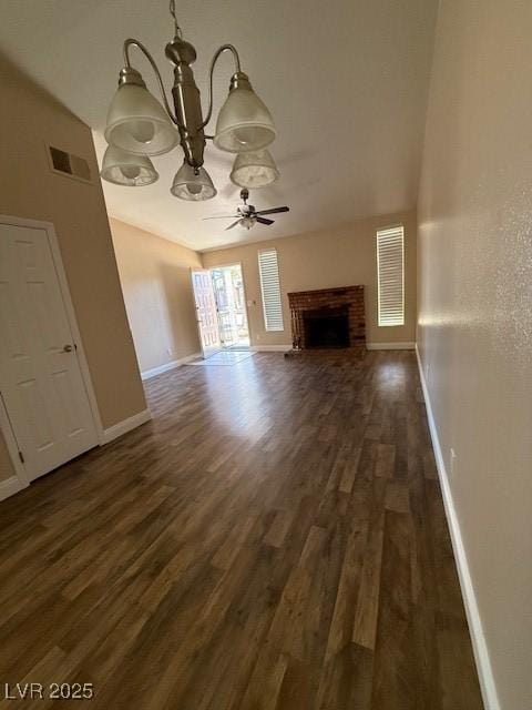 unfurnished living room with a brick fireplace, dark hardwood / wood-style flooring, and ceiling fan