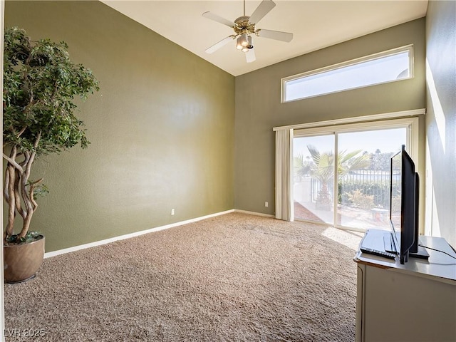 carpeted spare room with ceiling fan