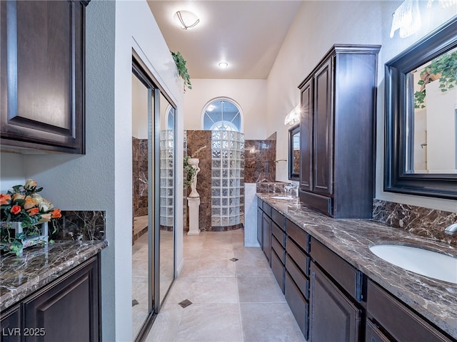 bathroom with vanity and tiled shower